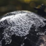 Detailed black and white close-up image of a globe focusing on Asia, highlighting geographical details.